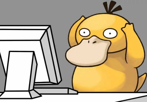 Psyduck at a Computer looking Confused.